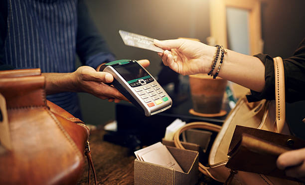 Cropped shot of a customer paying for her purchase with a credit card